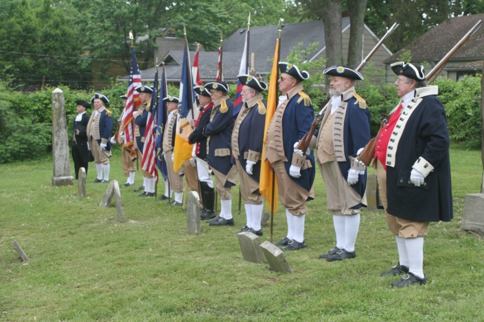 Kansas SAR Color Guard in colonial uniform presenting colors at a cemetery